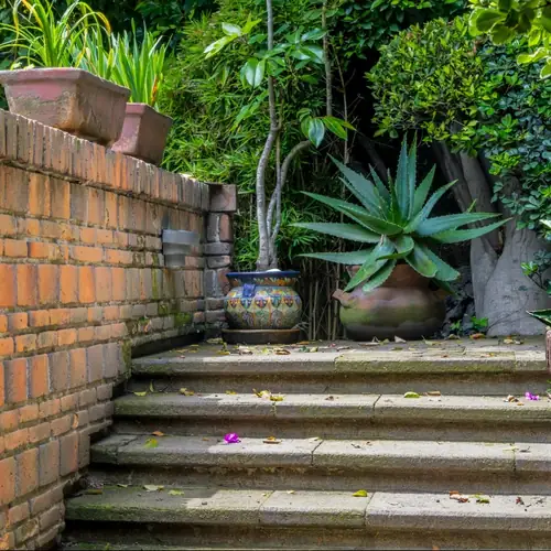Stone steps beside a brick wall