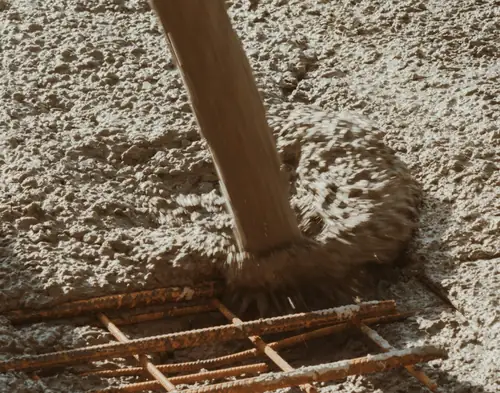 Concrete being placed over steel mesh